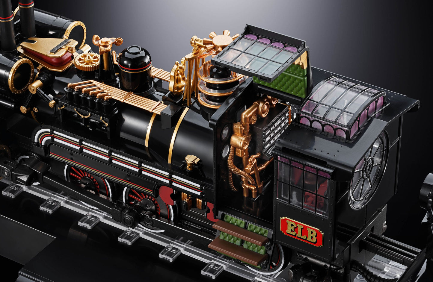 Detailed model of a steam locomotive with gold and red accents on a dark background