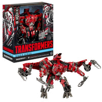 Transformers action figure with red and silver design next to its packaging