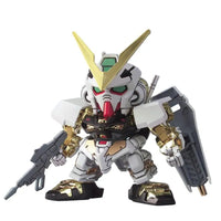 Front view of Bandai BB299 Gundam Astray Gold Frame model kit featuring a white and metallic gold chibi robot figure.