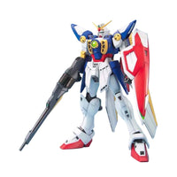 Front view of the Bandai MG Wing Gundam 1/100 model kit in red, white, and blue with a buster rifle and shield.