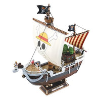 Bandai One Piece Going Merry ship model kit featuring a detailed ram figurehead, white sails with Jolly Roger, and deck crew.