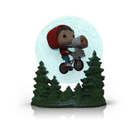 Funko POP! Elliott and E.T. flying on a bicycle in front of a glowing moon base with green pine trees.