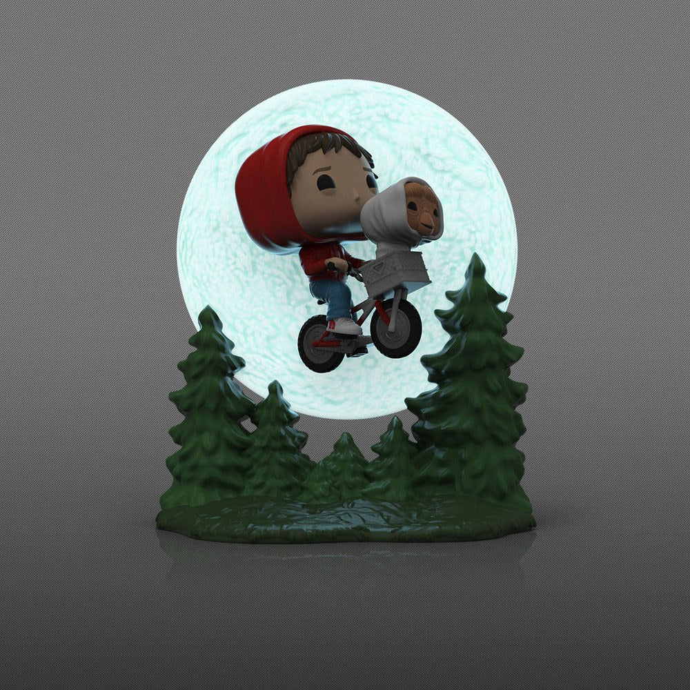 Funko POP! Elliott and E.T. flying on a bicycle in front of a glowing moon with green pine trees at the base.