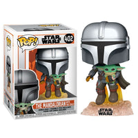 Funko Pop The Mandalorian with The Child vinyl figure flying on a flame base next to its branded display box.