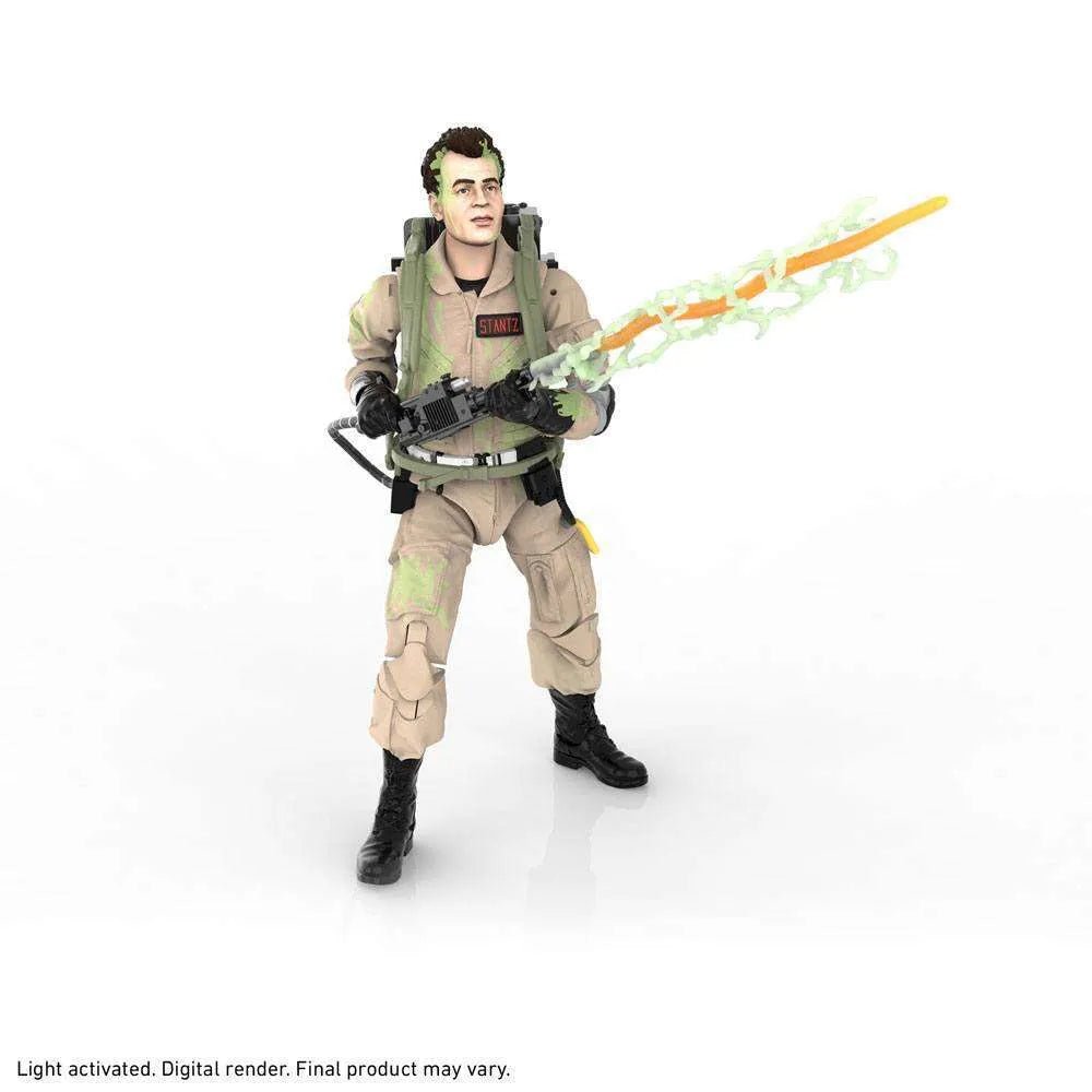Hasbro Ghostbusters Ray Stanz 6-inch action figure in a tan jumpsuit with a proton pack and glowing green energy blast.