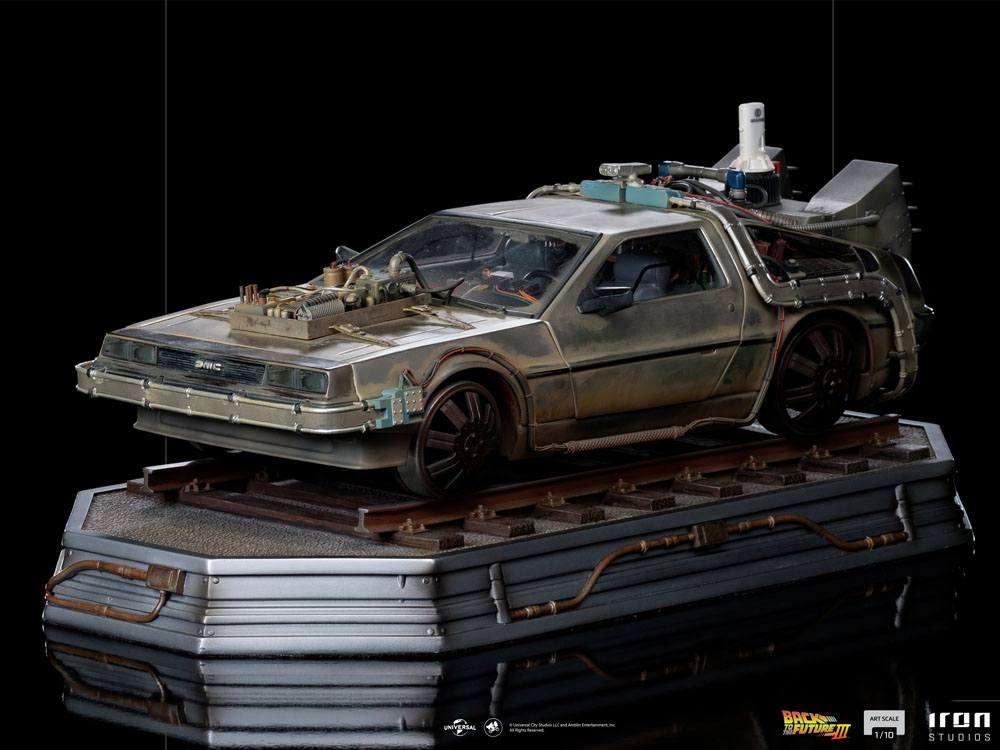 Iron Studios 1/10 scale Back to the Future III DeLorean statue on a train track base, side view with weathered finish.