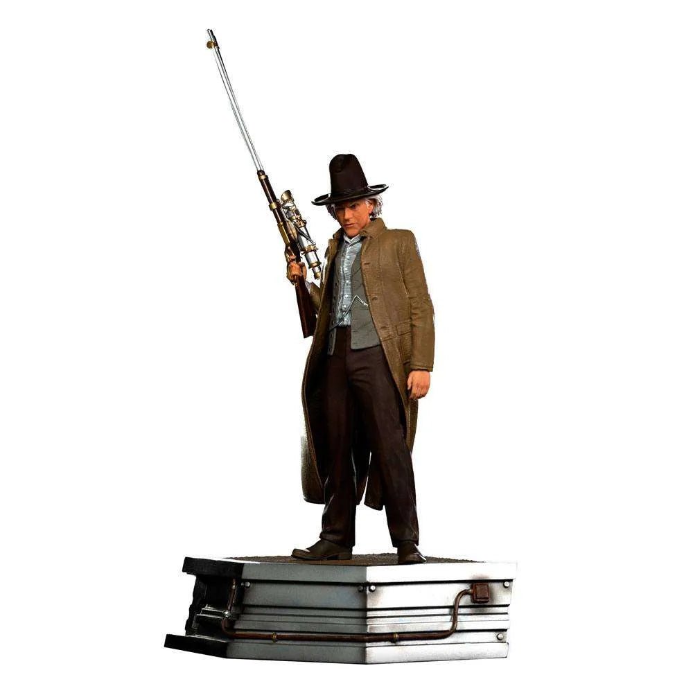 Iron Studios 1/10 Doc Brown statue from Back to the Future III, featuring the character holding a rifle on a base.
