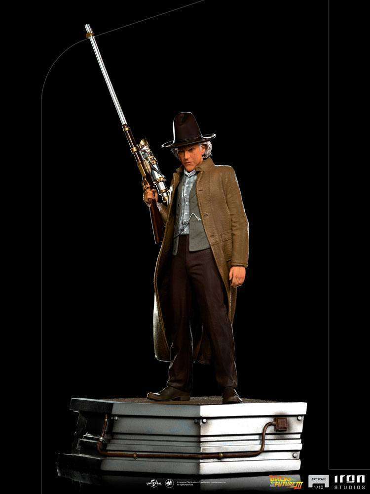 Iron Studios 1/10 Doc Brown statue from Back to the Future III, featuring the character holding a rifle on a base.