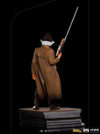 Back view of Iron Studios Doc Brown 1/10 scale statue wearing a brown duster coat and hat, holding a long rifle.