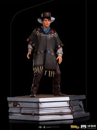 Iron Studios 1/10 Marty McFly statue from Back to the Future III wearing a poncho and hat on a metallic base.