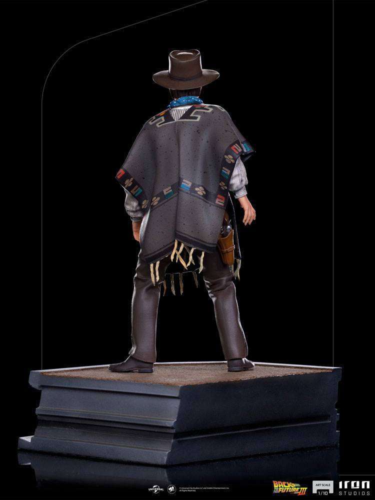 Back view of Iron Studios 1/10 Marty McFly statue wearing a patterned poncho, cowboy hat, and holster on a base.