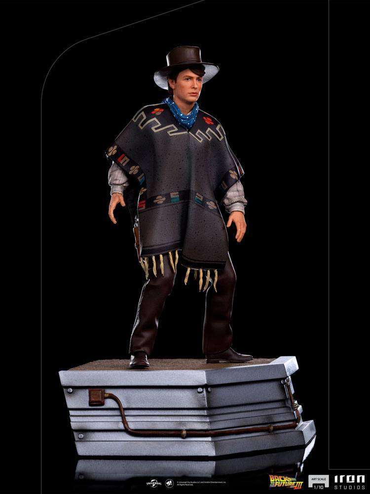 Iron Studios 1/10 Marty McFly statue from Back to the Future III wearing a western poncho and hat on a metallic base.