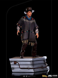 Iron Studios 1/10 Marty McFly statue from Back to the Future III wearing a western poncho and hat on a metallic base.