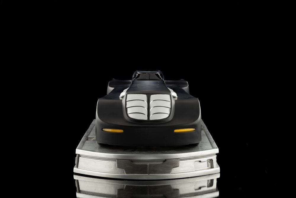 Front view of the Iron Studios Batman The Animated Series 1/10 Batmobile in matte black on a metallic display base.