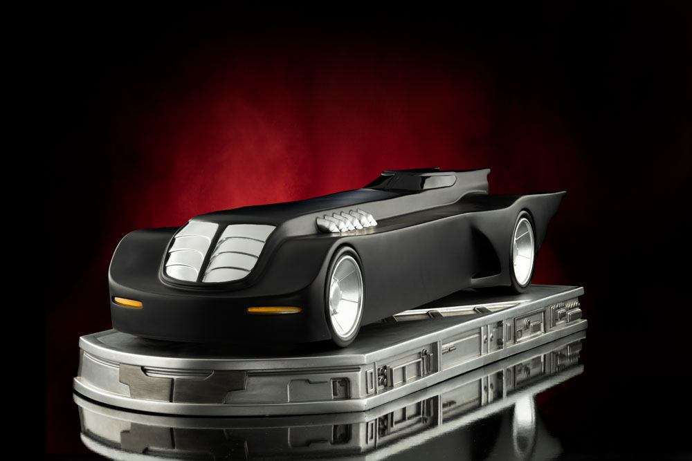 Side view of the matte black Iron Studios Batman The Animated Series Batmobile 1/10 scale statue on a metallic base.