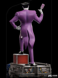 Back view of Iron Studios Batman The Animated Series Joker 1/10 scale statue in a purple suit holding a playing card.