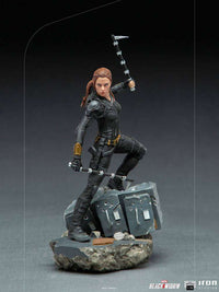 Iron Studios Black Widow 1/10 scale statue in a black tactical suit, holding batons on a rubble-textured display base.