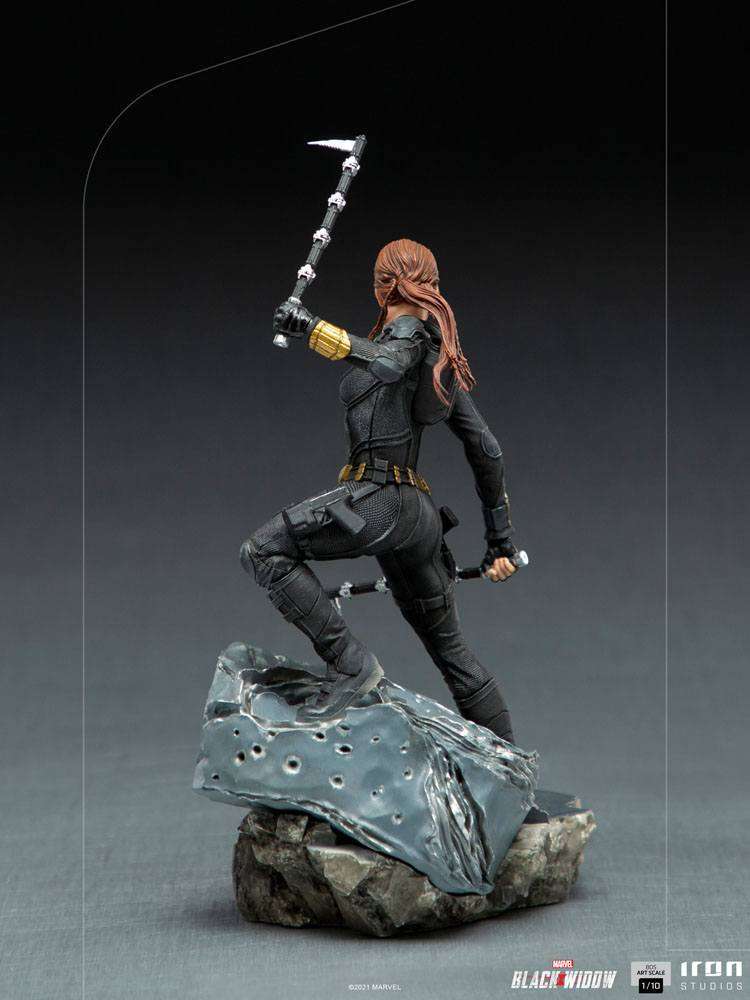 Rear view of Iron Studios Black Widow 1/10 scale statue in a black tactical suit, wielding batons on a rocky base.