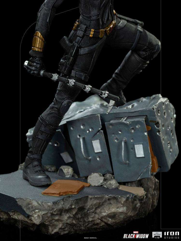 Close-up of Iron Studios Black Widow 1/10 statue showing her black tactical suit, utility belt, and baton on rubble base.