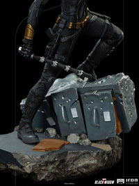 Close-up of Iron Studios Black Widow 1/10 statue showing her black tactical suit, utility belt, and baton on rubble base.