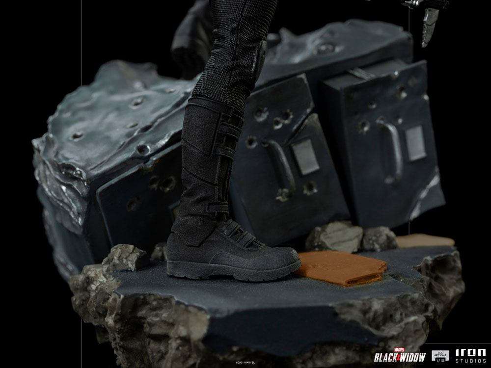 Close-up of the black tactical boots on an Iron Studios Black Widow 1/10 scale statue standing on a rubble base.