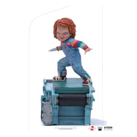 Iron Studios Child's Play 2 Chucky 1/10 scale statue featuring the doll holding a knife on a factory conveyor base.