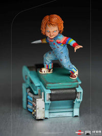 Iron Studios 1/10 scale Chucky statue from Child's Play 2, featuring the doll with a blade hand on a factory base.