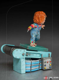 Side view of the 15 cm Iron Studios Child's Play 2 Chucky statue standing on a detailed factory conveyor belt base.