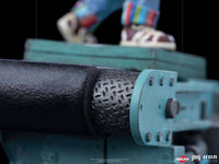 Close-up of the Iron Studios Child's Play 2 Chucky 1/10 statue base, featuring a textured black and teal conveyor belt.