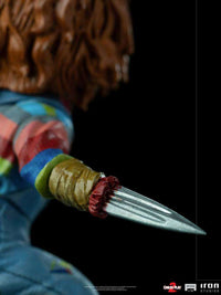 Close-up of the Iron Studios Child's Play 2 Chucky 1/10 scale statue, showing his hand replaced by a sharp metal blade.