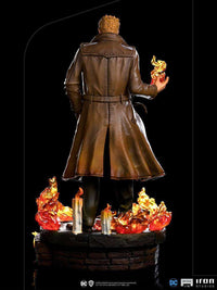 Back view of Iron Studios 1/10 Constantine statue wearing a brown trench coat with magical fire effects on a base.