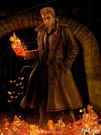 Iron Studios 1/10 scale Constantine statue featuring the character in a trench coat holding magical fire flames.