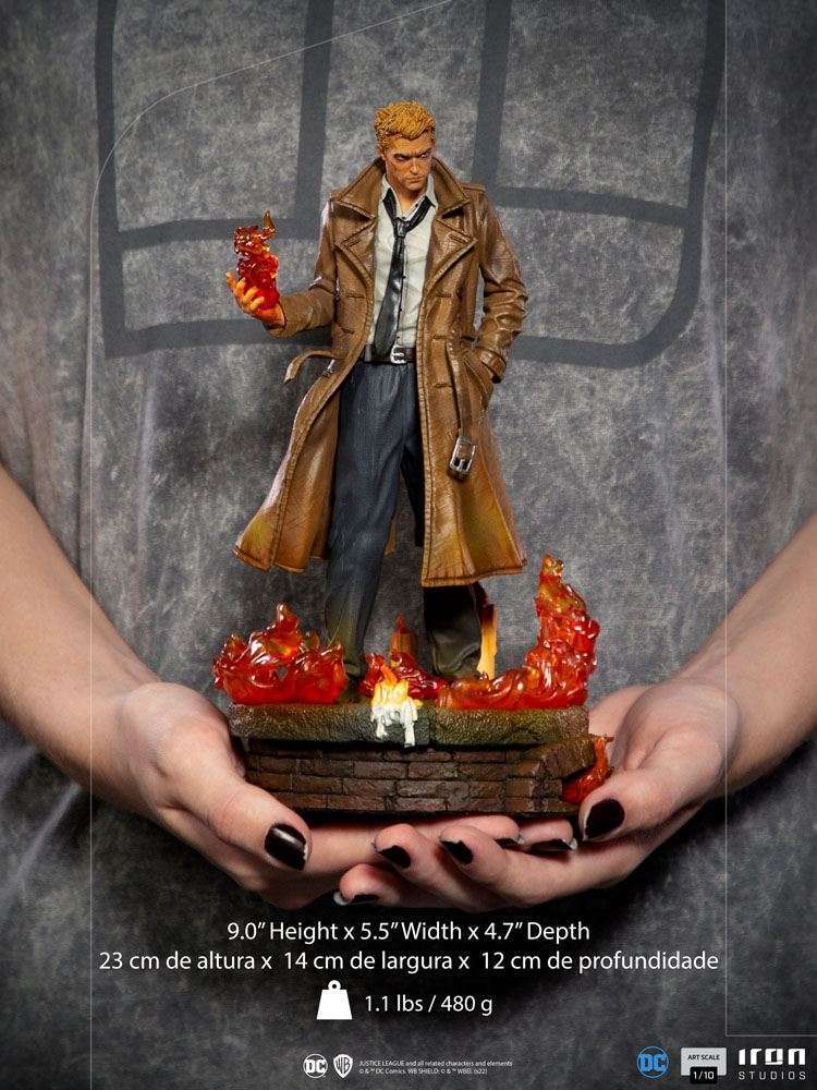 Iron Studios 1/10 Constantine statue in a brown trench coat, holding magical fire over a brick base with flames.