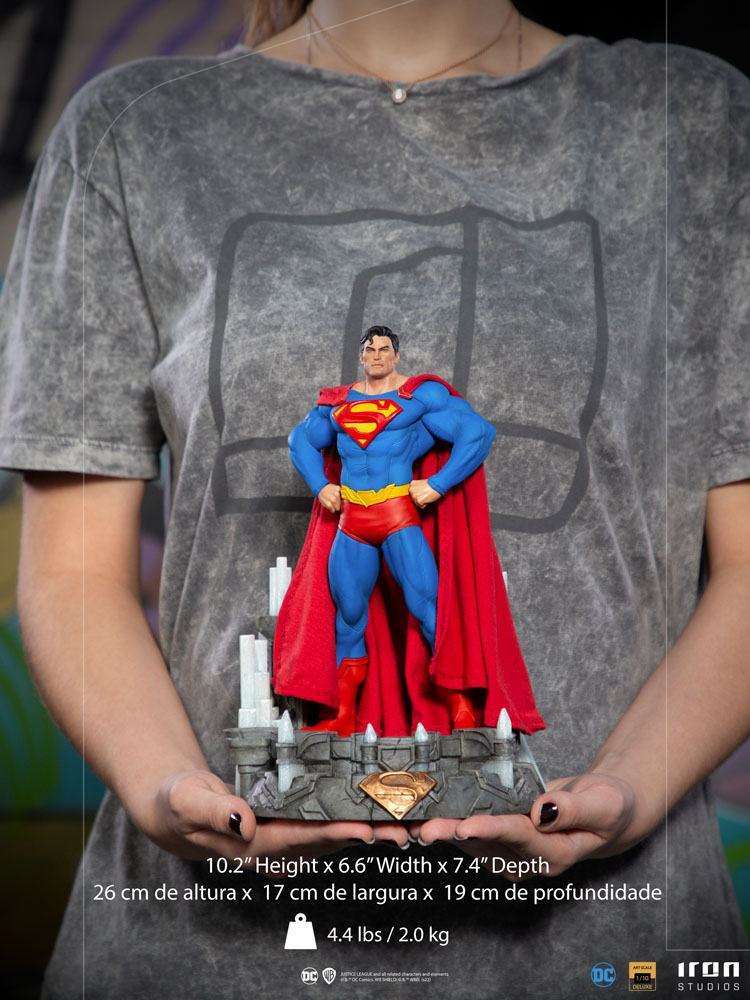 Iron Studios 1/10 Superman Unleashed Deluxe statue in a front view, held in hands, featuring a detailed base and cape.