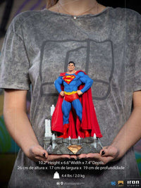 Iron Studios 1/10 Superman Unleashed Deluxe statue in a front view, held in hands, featuring a detailed base and cape.