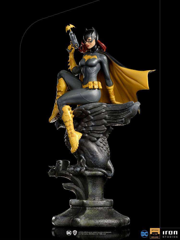 Iron Studios 1/10 Batgirl Deluxe Art Scale statue in a side view, featuring a dark suit, yellow cape, and bat-signal gun.
