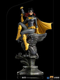 Iron Studios 1/10 Batgirl Deluxe Art Scale statue featuring the hero in a grey and yellow suit perched on a stone eagle.