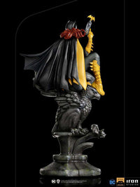 Rear view of Iron Studios 1/10 Batgirl Deluxe Art Scale statue perched on a stone gargoyle with a flowing black cape.