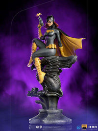 Iron Studios 1/10 Batgirl Deluxe Art Scale statue featuring the hero in a black and yellow suit perched on a stone gargoyle.