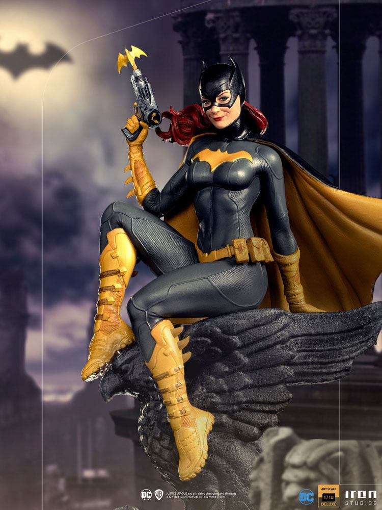 Iron Studios 1/10 Batgirl Deluxe Art Scale statue featuring the hero in a black and gold suit, perched on a stone gargoyle.