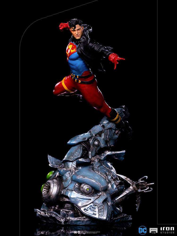Iron Studios 1/10 Superboy statue in a dynamic flying pose, wearing a black leather jacket over his iconic suit.