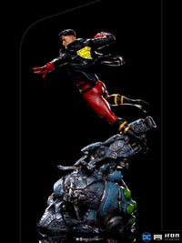 Side view of 28cm Iron Studios Superboy 1/10 scale statue in a black leather jacket, leaping over a metallic base.