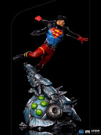 Iron Studios 1/10 Superboy statue in a dynamic flying pose, wearing a black leather jacket over a blue and red suit.
