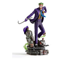 Iron Studios 1/10 The Joker statue in a purple suit holding a crowbar, standing on a detailed industrial base.