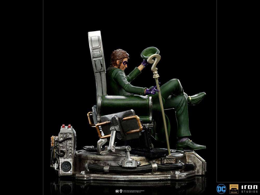 Side view of Iron Studios 1/10 The Riddler statue, featuring him in a green suit sitting on a detailed tech chair.