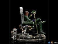 Side view of Iron Studios 1/10 The Riddler statue, featuring him in a green suit sitting on a detailed tech chair.