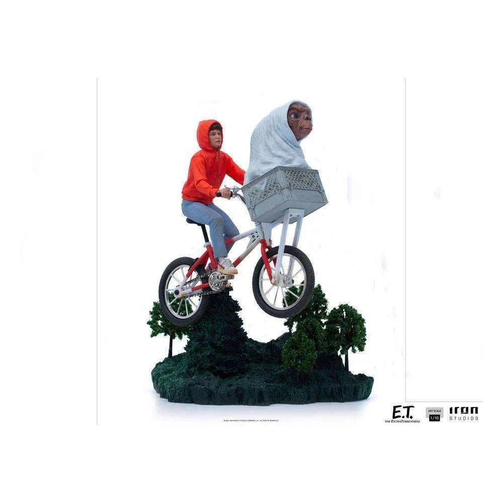Iron Studios 1/10 E.T. & Elliot statue featuring Elliot riding a bicycle with E.T. in the front basket over a forest base.