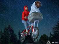 Iron Studios 1/10 scale E.T. & Elliot statue featuring Elliot on a bicycle with E.T. in the basket against a starry sky.