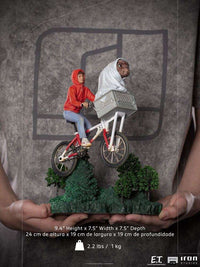 Iron Studios E.T. & Elliot 1/10 scale statue featuring the duo on a bicycle flying over a green forest base.