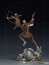 Rear view of Iron Studios 1/10 Kratos & Atreus statue, showing detailed armor and weapons on a rocky base.